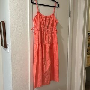 Peach spaghetti strap dress with tie detail at the waist and pockets
